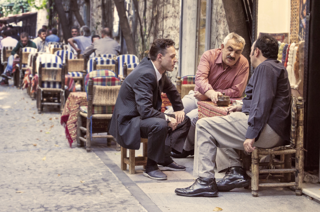 photo of men sitting around table