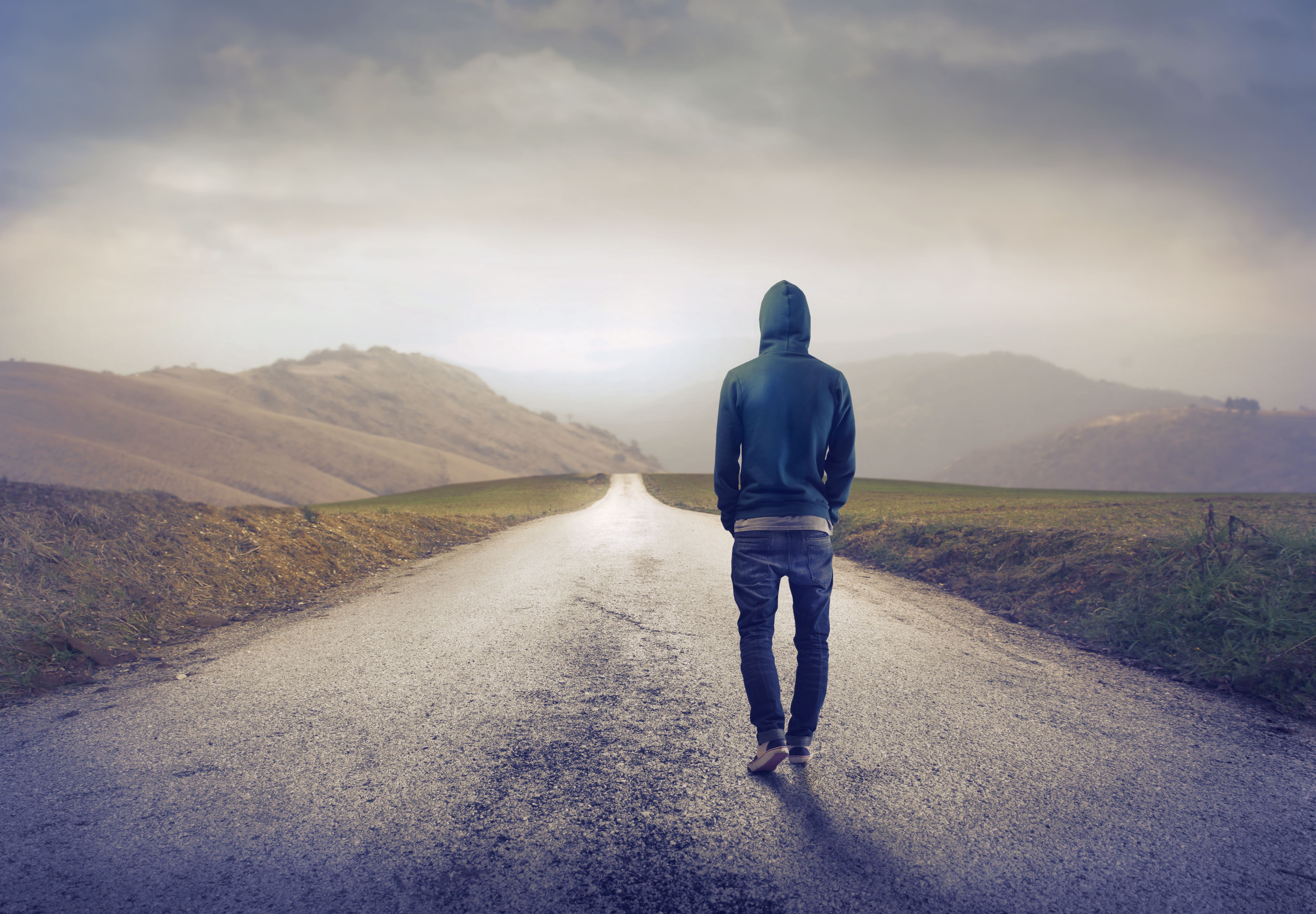 photo of man walking down road