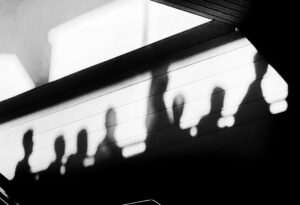 people shadows near wall