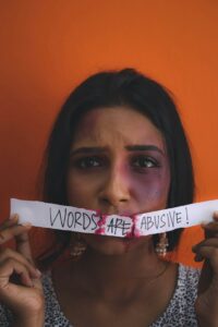 a woman holding a piece of paper with words on it